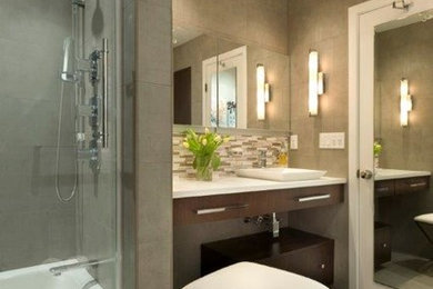 Large minimalist master beige tile and porcelain tile porcelain tile bathroom photo in New York with flat-panel cabinets, brown cabinets, a one-piece toilet, beige walls, a trough sink and solid surface countertops