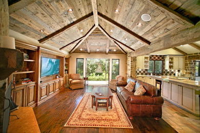 Inspiration for a mid-sized rustic open concept dark wood floor and brown floor family room remodel in Orange County with beige walls, a standard fireplace and no tv