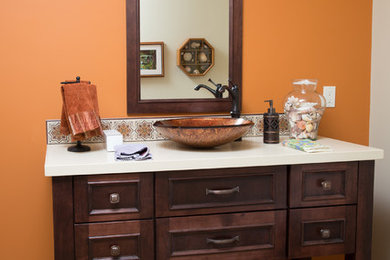 Example of a small classic multicolored tile light wood floor powder room design in San Francisco with a vessel sink, recessed-panel cabinets, medium tone wood cabinets, quartz countertops and orange walls