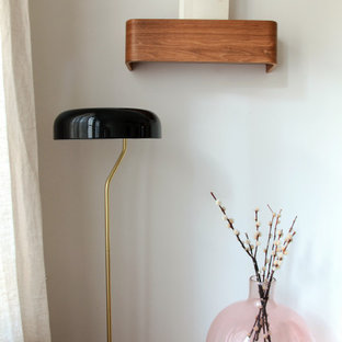 Design ideas for a mid-sized scandinavian guest bedroom in Paris with white walls, terra-cotta floors, no fireplace and red floor.