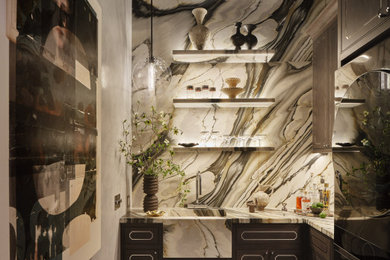 Utility room - small transitional u-shaped marble floor and multicolored floor utility room idea in San Francisco with an integrated sink, gray cabinets, marble countertops, blue walls and a stacked washer/dryer