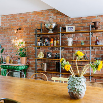 A fun and eclectic dining room with industrial shelving