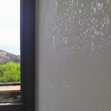 White opal glass pieces embedded in white lime plaster