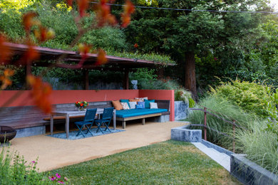 Design ideas for a mid-sized mid-century modern drought-tolerant and partial sun backyard decomposed granite and wood fence landscaping in San Francisco with a pergola.