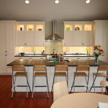 White eat in kitchen with back splash windows.