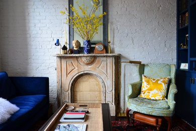 Small eclectic open concept dark wood floor living room photo in New York with white walls, a standard fireplace, a brick fireplace and a media wall