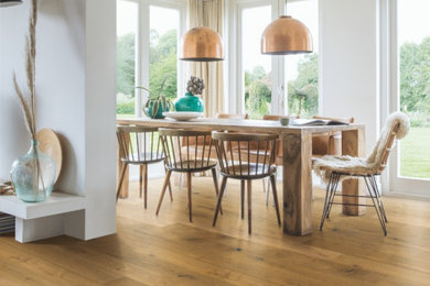 Mountain style medium tone wood floor and brown floor dining room photo in Other