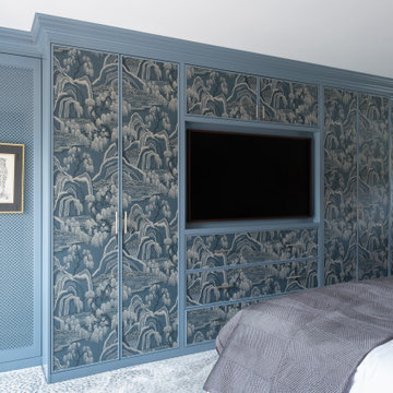 Bespoke fitted wardrobes with wallpapered panels