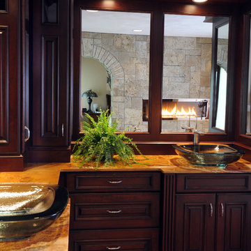 Master Bathroom with Glass Vessel Sinks and a Two Sided Fireplace