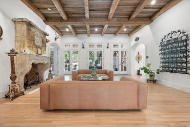 Elegant formal and enclosed light wood floor, brown floor and exposed beam living room photo in Dallas with white walls, a standard fireplace and no tv