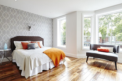 Large transitional guest bedroom in Toronto with grey walls, medium hardwood floors and no fireplace.