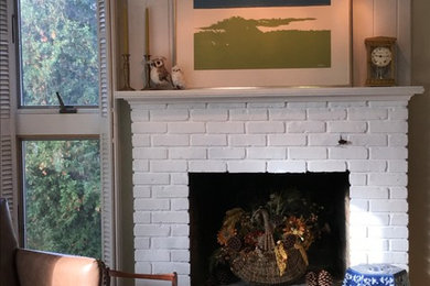 Mid-sized transitional open concept medium tone wood floor and brown floor living room photo in Other with green walls, a standard fireplace and a brick fireplace