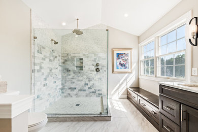Inspiration for a huge transitional master marble floor and multicolored floor corner shower remodel in Houston with recessed-panel cabinets, dark wood cabinets, a two-piece toilet, beige walls, an undermount sink, marble countertops and a hinged shower door