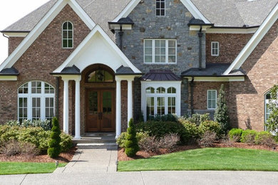 Inspiration for a huge brown three-story brick gable roof remodel in Nashville