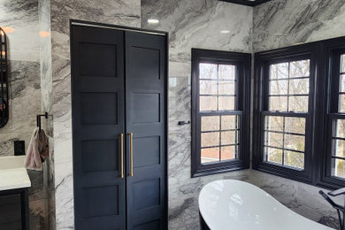 Inspiration for a large modern master black and white tile and porcelain tile cement tile floor, multicolored floor and double-sink bathroom remodel in Philadelphia with shaker cabinets, black cabinets, a one-piece toilet, an undermount sink, quartzite countertops, a hinged shower door, white countertops, a niche and a freestanding vanity