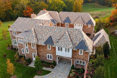Huge french country brown three-story wood and clapboard exterior home photo in Nashville with a tile roof and a brown roof