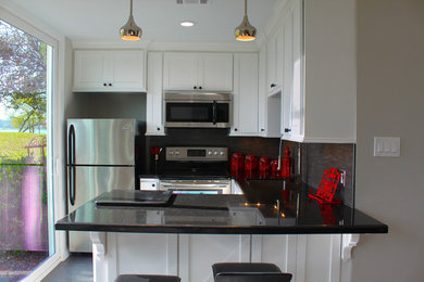 Small minimalist porcelain tile kitchen photo in Houston with an undermount sink, shaker cabinets, white cabinets, granite countertops, gray backsplash, stainless steel appliances and no island