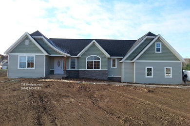 Mid-sized eclectic green one-story mixed siding gable roof idea in Grand Rapids