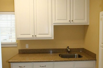 Small elegant single-wall porcelain tile and beige floor dedicated laundry room photo in Other with an undermount sink, raised-panel cabinets, white cabinets, granite countertops, yellow walls and a side-by-side washer/dryer