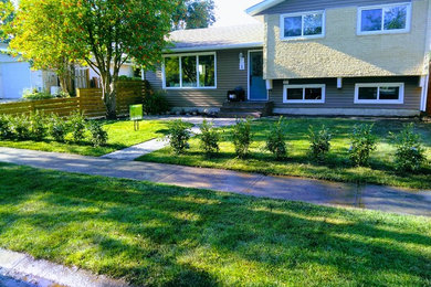 Inspiration for a large timeless gray two-story vinyl exterior home remodel in Edmonton with a shingle roof