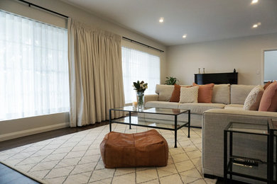 Inspiration for a transitional living room in Sydney with dark hardwood floors and brown floor.