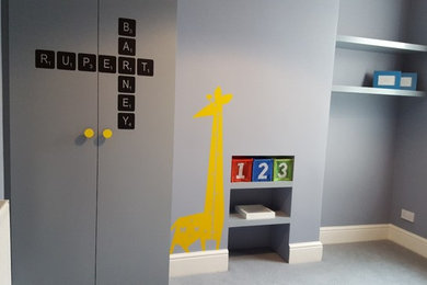 This is an example of a mid-sized scandinavian kids' room for boys in London with grey walls, carpet and grey floor.