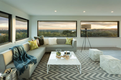 Large trendy open concept light wood floor family room photo in Austin with white walls and a concealed tv