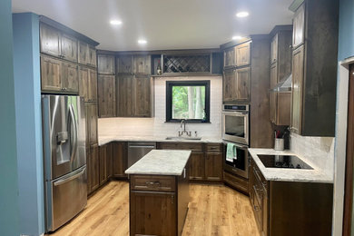 Large elegant u-shaped kitchen pantry photo in Charleston with dark wood cabinets, marble countertops, subway tile backsplash and an island