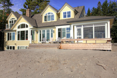 Inspiration for a large timeless yellow two-story wood exterior home remodel in Toronto