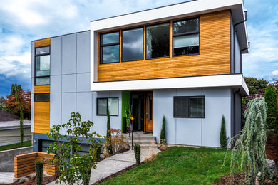 Design ideas for a mid-sized contemporary two-storey exterior in Seattle with concrete fiberboard siding.