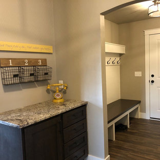 Immagine di un ingresso con anticamera minimalista di medie dimensioni con pareti beige, pavimento in vinile, una porta singola, una porta bianca e pavimento marrone