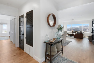 Hallway - traditional medium tone wood floor hallway idea in San Francisco with white walls