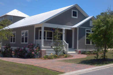 Inspiration for a small contemporary gray one-story wood exterior home remodel in Orlando with a metal roof