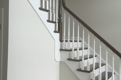 Inspiration for a mid-sized timeless wooden l-shaped wood railing staircase remodel in Chicago with painted risers