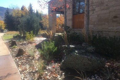 This is an example of a mid-sized modern drought-tolerant and partial sun front yard stone garden path in Other for summer.