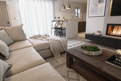 Photo of a small rustic cream and black living room feature wall in Other with white walls, laminate floors, a ribbon fireplace, a tiled fireplace surround, a built-in media unit, exposed beams and brick walls.