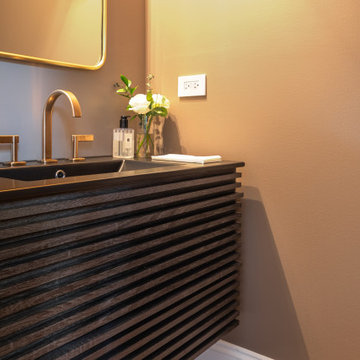 Floating Fluted Walnut Vanity with Wall-Mounted Brass Faucet in Warm Modern Powd