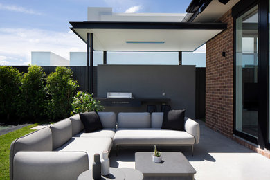 Large and brown contemporary two floor brick detached house in Melbourne with a tiled roof and a grey roof.