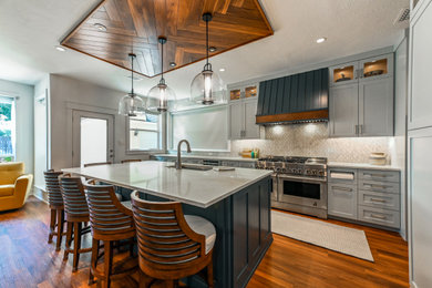 Large minimalist tray ceiling open concept kitchen photo in Houston with shaker cabinets, white cabinets, quartz countertops, multicolored backsplash, mosaic tile backsplash, stainless steel appliances and an island