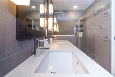 Doorless shower - mid-sized modern gray tile and ceramic tile ceramic tile doorless shower idea in Vancouver with an undermount sink, flat-panel cabinets, dark wood cabinets, granite countertops, a two-piece toilet and gray walls