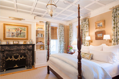 Bedroom - mid-sized traditional master light wood floor and gray floor bedroom idea in New York with beige walls, a standard fireplace and a stone fireplace