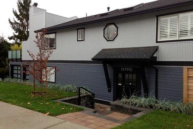 Mid-sized modern blue one-story mixed siding gable roof idea in Vancouver
