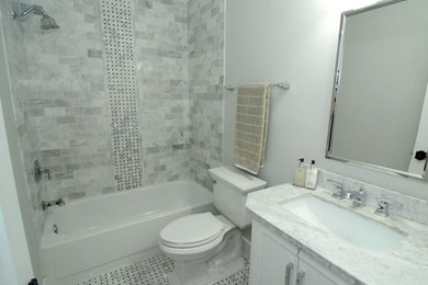 Inspiration for a small timeless kids' gray tile and marble tile marble floor and multicolored floor bathroom remodel in Orlando with raised-panel cabinets, white cabinets, a one-piece toilet, gray walls, an undermount sink, marble countertops and gray countertops