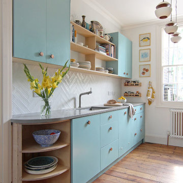 Kitchen With Copper Handles and Concrete Worktop