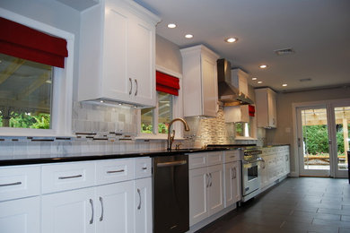 Photo of a large transitional single-wall separate kitchen in Philadelphia with an undermount sink, shaker cabinets, white cabinets, quartz benchtops, multi-coloured splashback, matchstick tile splashback, stainless steel appliances, porcelain floors and no island.