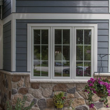 Shiny new Andersen Windows, Evening Blue James Hardie siding & stone accents