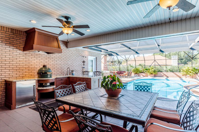 Inspiration for a small transitional l-shaped porcelain tile eat-in kitchen remodel in Miami with an undermount sink, shaker cabinets, brown cabinets, granite countertops, stainless steel appliances and no island