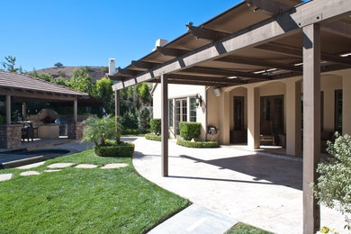 Design ideas for a huge mediterranean partial sun backyard concrete paver water fountain landscape in Los Angeles.