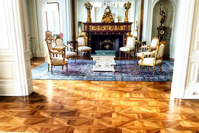 Inspiration for a large victorian formal and enclosed medium tone wood floor and brown floor living room remodel in New York with beige walls, a standard fireplace, a wood fireplace surround and no tv
