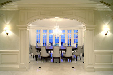 Photo of a transitional separate dining room in Toronto with white walls and marble floors.